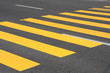 Yellow painted pedestrian crossing on the road.