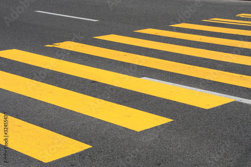 Photo: Yellow painted pedestrian crossing on the road. Yellow painted pedestrian crossing on the road.