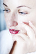 portrait of woman touching her face portrait of woman touching her face