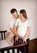 Photo: Young Expecting Parents standing by a crib Young Expecting Parents standing by a crib