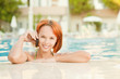 Smiling woman in bikini in pool