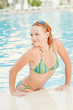Smiling woman in bikini in pool