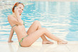 Smiling woman in bikini in pool