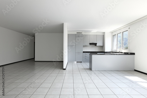 Photo: new apartment, empty room with white tiled floor new apartment, empty room with white tiled floor