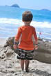 Photo: Boy looking at sand castle Boy looking at sand castle