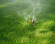 Sprinkler Spraying Water On Grass