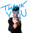Young man writing Thank YOU on whiteboard