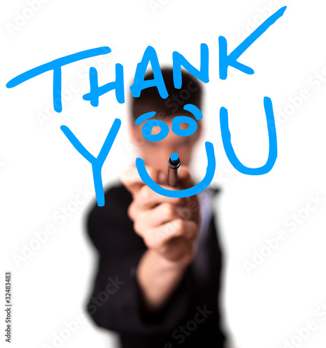 Photo: Young man writing Thank YOU on whiteboard Young man writing Thank YOU on whiteboard