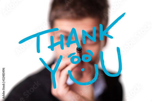 Photo: Young man writing Thank YOU on whiteboard Young man writing Thank YOU on whiteboard