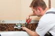 Plumber installing a mixer tap in a bathroom