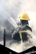 Fireman Putting out a House Fire Fireman Putting out a House Fire