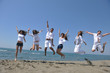 happy people group have fun and running on beach