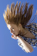 Portrait of thoughtful girl against blue sky