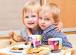 Cute children are eating dessert