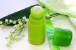 Lily of the valley, a towel and a green deodorant on the table