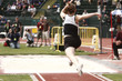 Photo: Female athlete competing on the "long jump" event Female athlete competing on the "long jump" event
