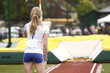 Photo: Female athlete competing in the pole vault Female athlete competing in the pole vault