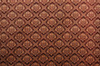 Thai painting pattern of golden brown silk cloth full frame.