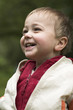 Little boy laughs in park