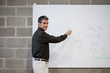 Professor standing at whiteboard with formula