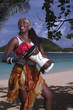 African musician plays the djembe rum at the beach African musician plays the djembe rum at the beach