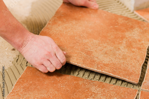 Photo: Tiler tiling tiles on the floor Tiler tiling tiles on the floor