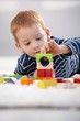Sweet gingerish boy building tower at home Sweet gingerish boy building tower at home