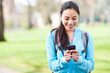 Photo: Asian student texting on the phone Asian student texting on the phone