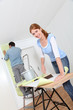 Couple putting new wallpaper in room Couple putting new wallpaper in room