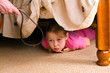 The child hides under a bed. Violence in a family.