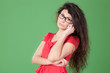 Portrait of young female in eye-glasses talking on phone