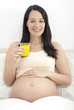 Pregnant woman holding glass of orange juice
