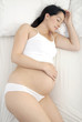 Pregnant woman in bed asleep