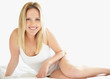 Beautiful young female sitting in lingerie on the bed
