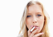 Pretty female smoking a cigarette against white background