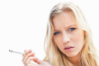 Blond woman smoking a cigarette against white background