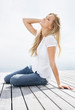 Relaxed woman sitting on a wooden porch