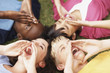 Shouting teenagers lying on grass in a circle