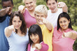 Portrait of happy teenagers pointing at you