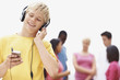Cute young boy hearing music on headphones