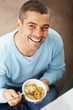 Happy young man eating cereal - Top view