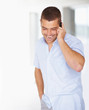 Happy young guy talking on mobile phone