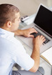 Casual young business man working on laptop
