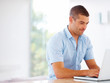 Photo: Confident young man working on laptop - Copyspace Confident young man working on laptop - Copyspace