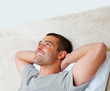 Happy young guy lying comfortably