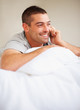 Happy young guy speaking on cellphone - Indoor