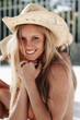 Happy lovely nude woman wearing a hat