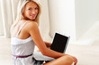 Beautiful young woman using laptop at home