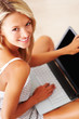 Portrait of pretty young woman using laptop
