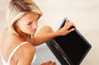 Pretty young lady using laptop at home